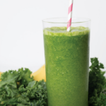 green smoothie in a glass with straw